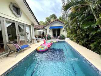 Mediterranean villa swimming pool surrounded by lush tropical landscaping in Buenaventura Panama