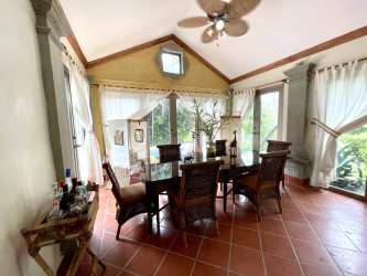 Dining area with vaulted ceiling, terracotta tiles, garden views in Buenaventura Resort villa