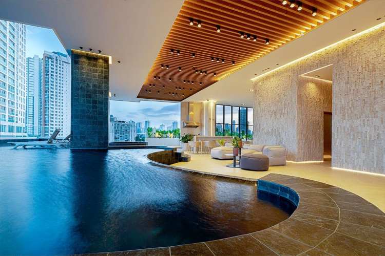 Balcony with lounge chairs, glass railing, city skyline views at PH Coco Place Coco del Mar