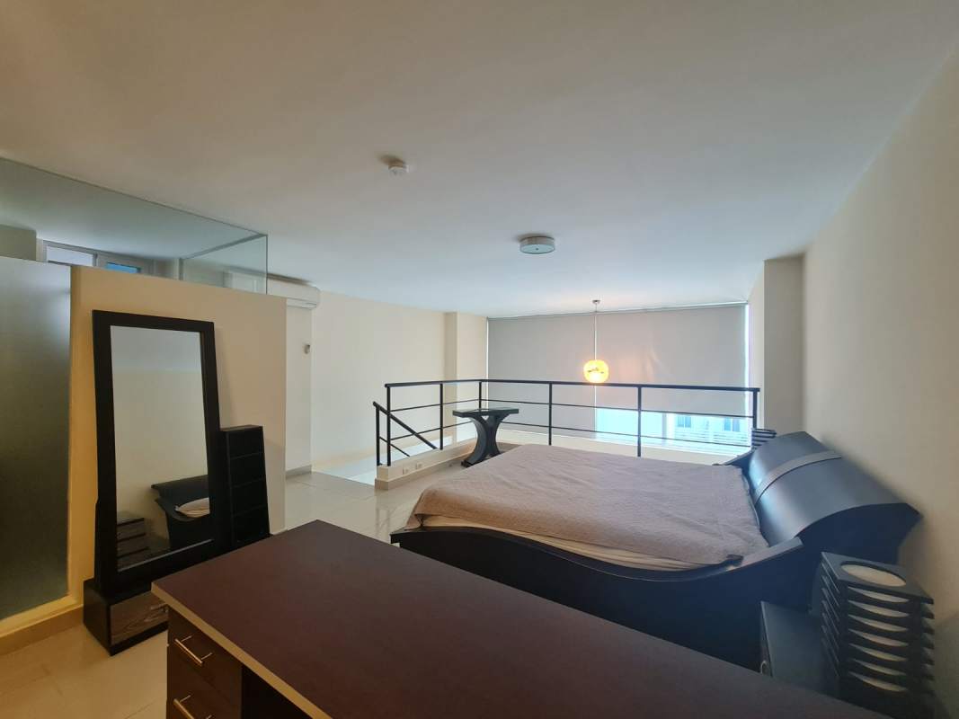 Upper bedroom view railing large window loft apartment Vitro Loft El Cangrejo Panama City