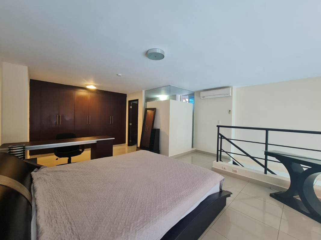 Loft style bedroom upper level overlooking living room Vitro Loft Panama City rental