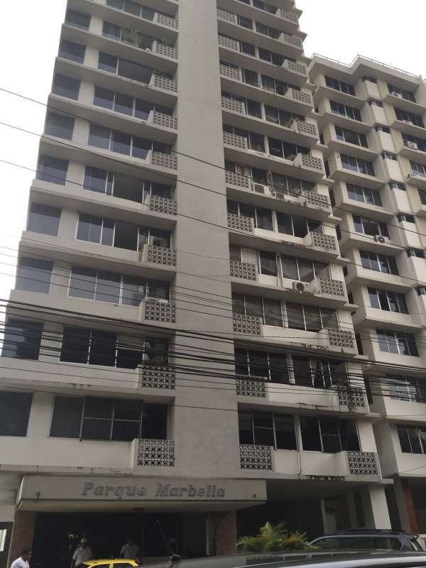 Large window view of Panama City high-rises and ocean from apartment at Parque Marbella
