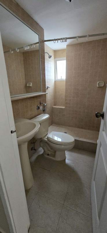 Bathroom featuring pedestal sink, mirror, shower area with window in PH San Francisco.