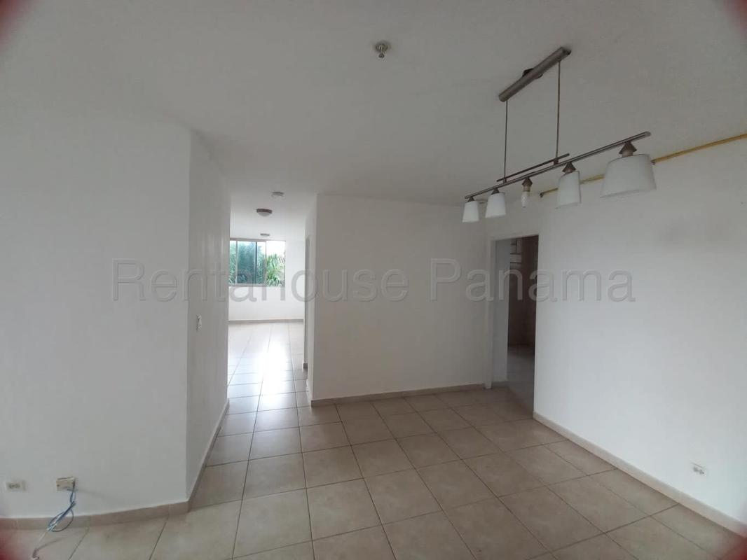Bright open-plan living dining area with tile flooring and large window PH Pacific Bay Panama