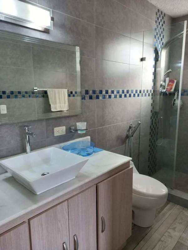 Modern bathroom vessel sink glass shower grey tiles PH El Carmen Panama