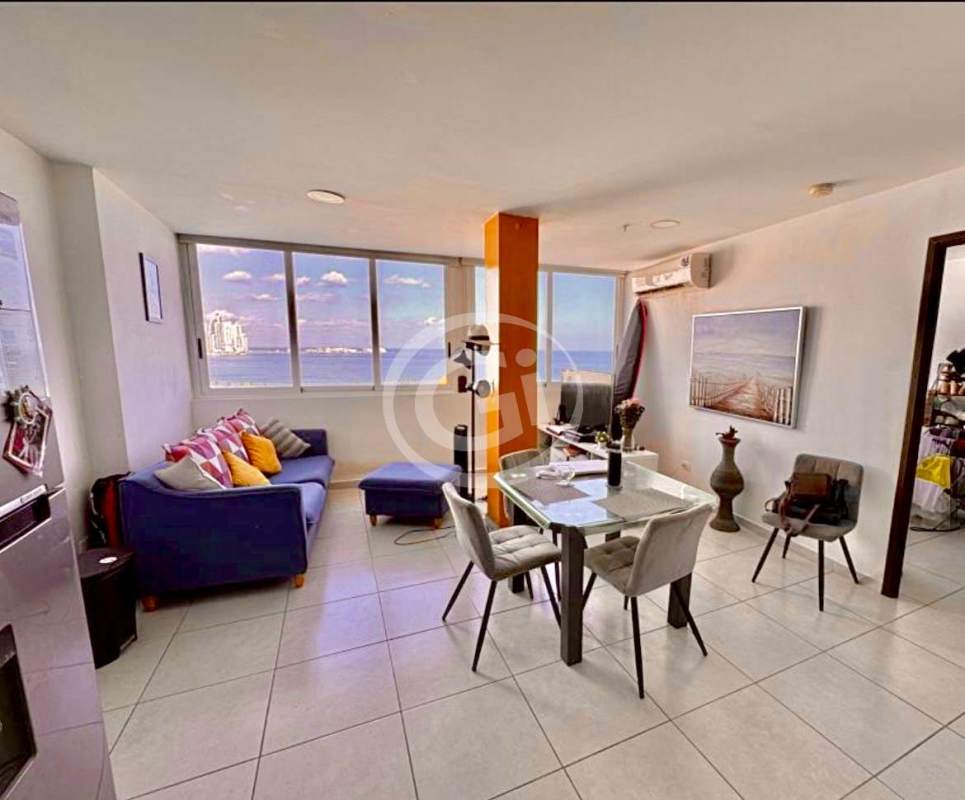 Modern living area with large windows and ocean view fully furnished at PH Bay View Avenida Balboa Panama