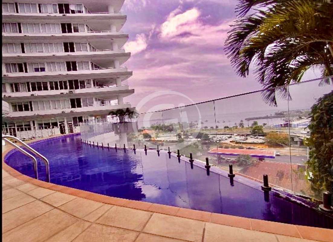 Curved infinity rooftop pool with ocean view beside PH Bay View condo Panama City