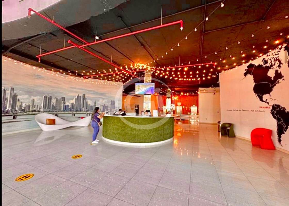 Lobby reception with grass desk, cityscape mural, and art at PH Bay View Panama