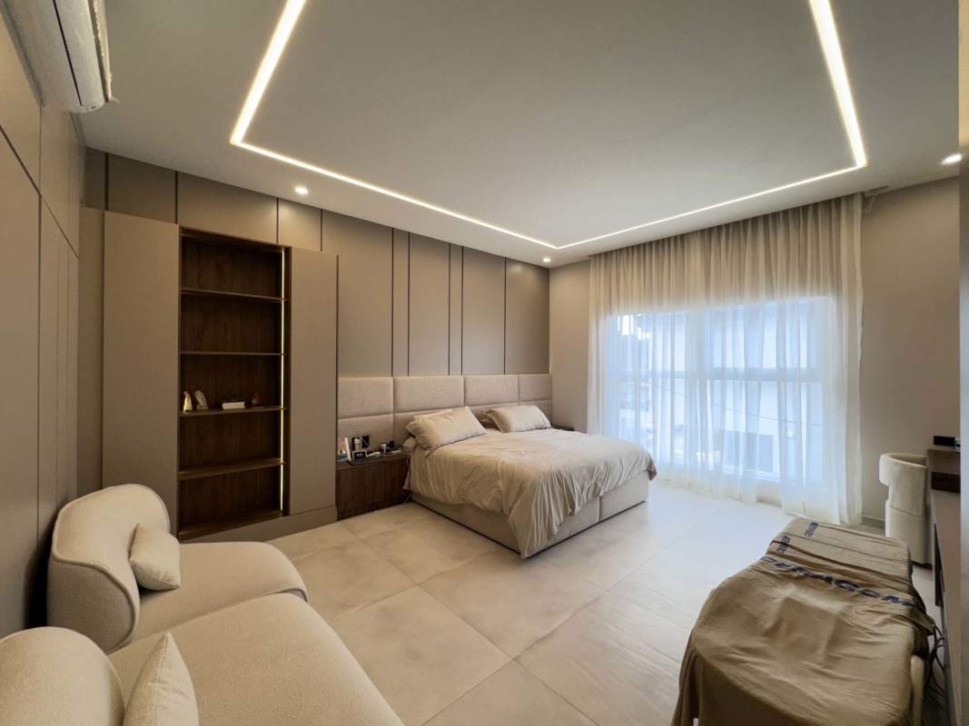 Modern staircase with minimalist design overlooking spacious living area in The Woods Santa María Panama house rental