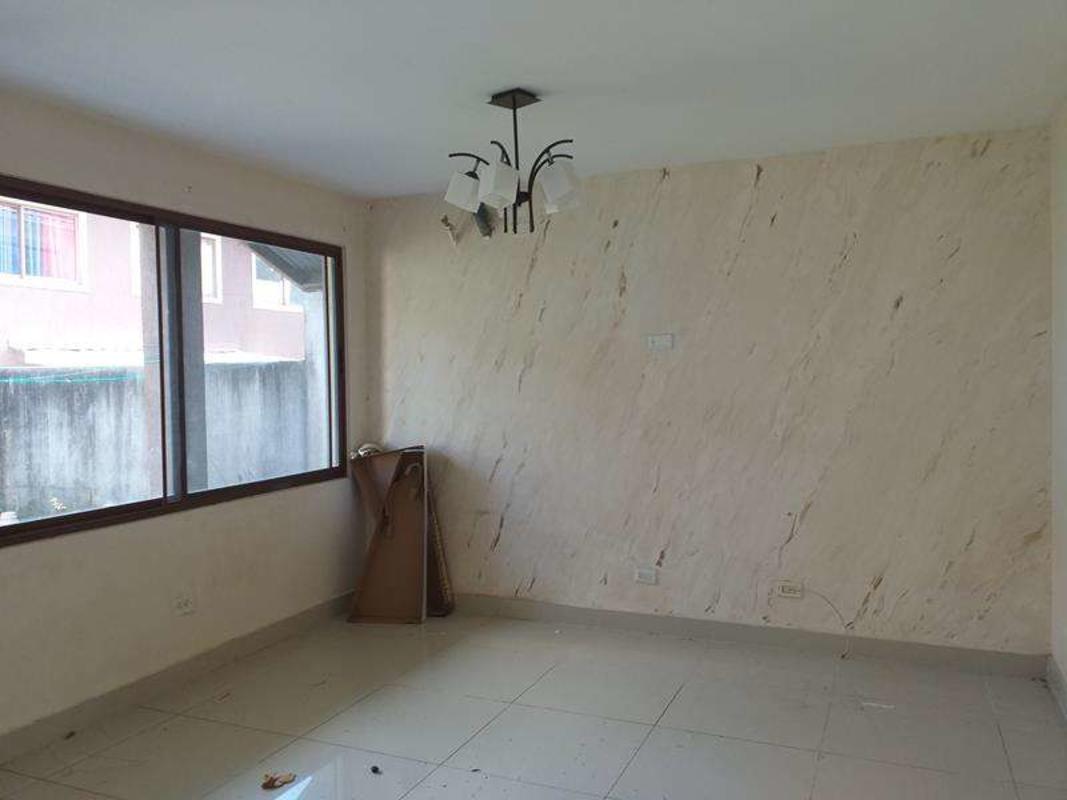 Modern living room marble accent wall large window townhouse PH Green Village Panama