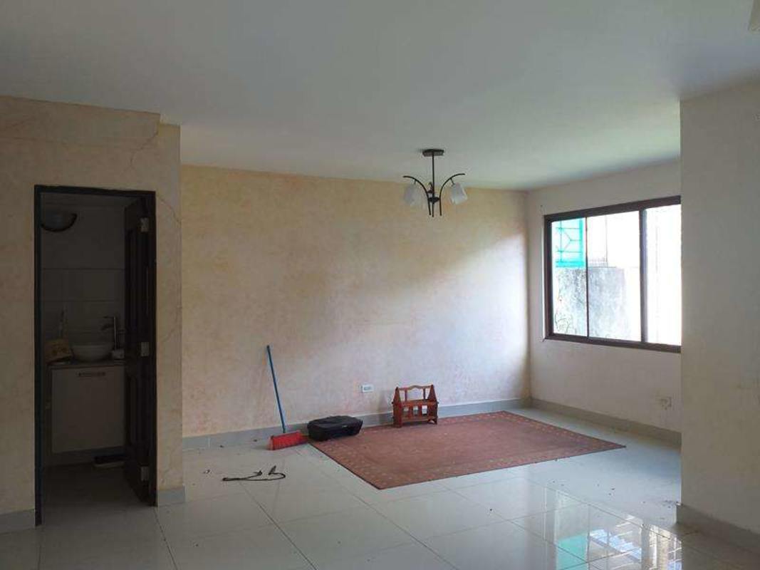 Minimalist living room with tile floor large window neutral tones townhouse PH Green Village Panama