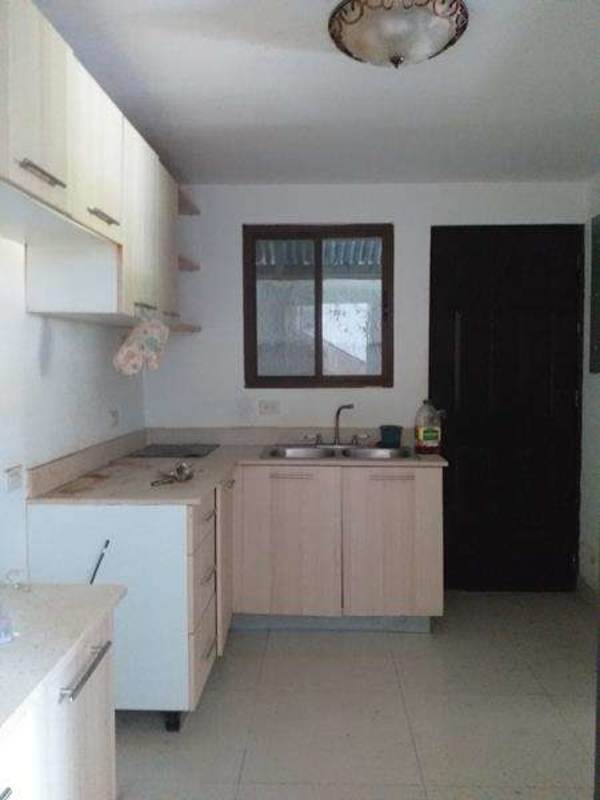 Simple kitchen with wooden cabinets window ceramic tile townhouse PH Green Village Panama
