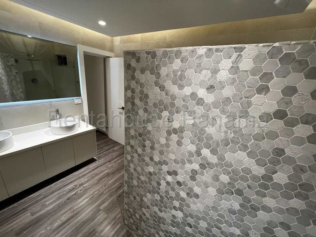 Contemporary bathroom with double sinks, glass shower and porcelain tile at PH Joy Tower Panama
