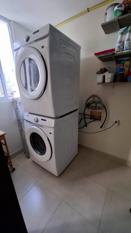 Open kitchen with white line appliances and cabinetry in PH Nuevo Obarrio Obarrio Panama