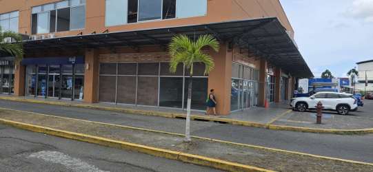 Exterior modern corner commercial unit with large windows at Centro Comercial 4 Altos Colón