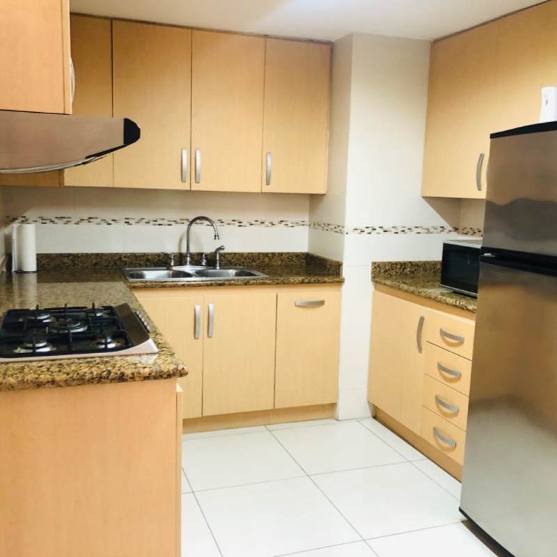 Furnished kitchen with granite counters and stainless appliances in PH BICSA Tower apartment Panama