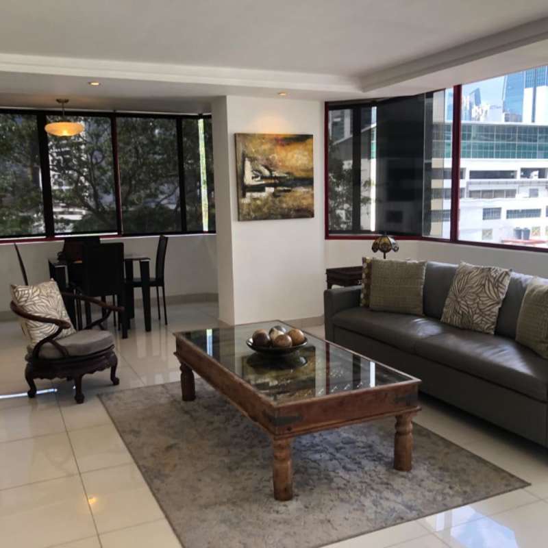 Living room with large windows showcasing ocean and city skyline in PH BICSA Financial Center Panama