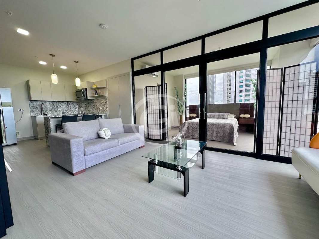 Elegant bedroom with large windows offering Pacific Ocean and park views at PH Arcadia Costa del Este