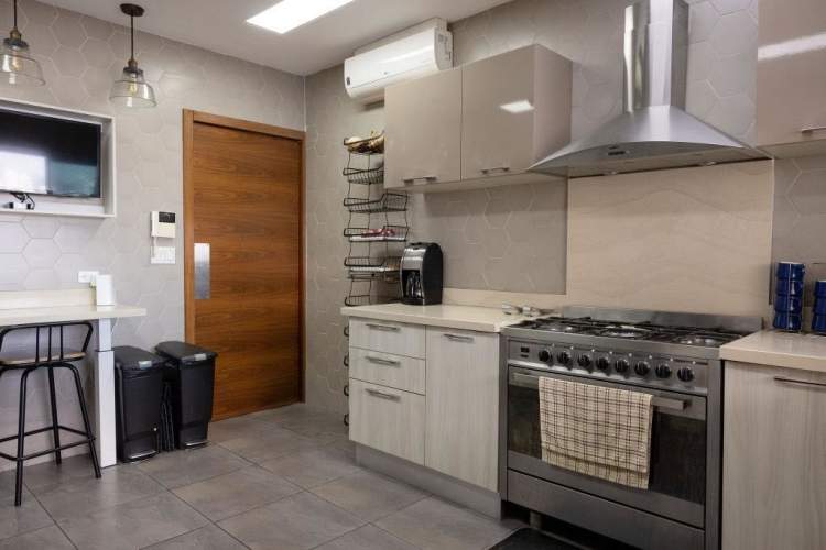 Contemporary kitchen with granite counters, stainless appliances in PH Bahía del Golf Panama