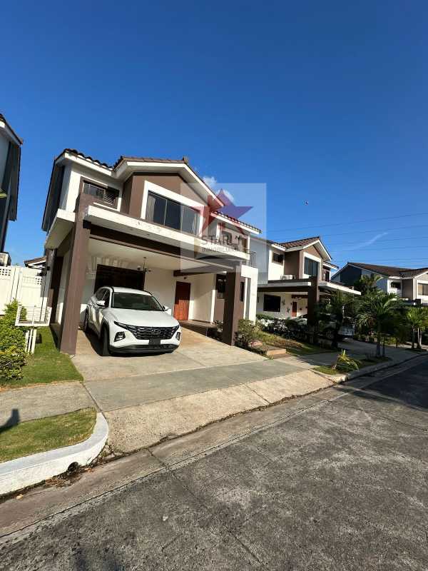 Kitchen with granite counter center island natural light and wooden cabinets in Brisas Norte