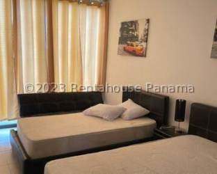 Furnished twin bedroom with large windows and AC at Village at The Pool Rio Hato Panama
