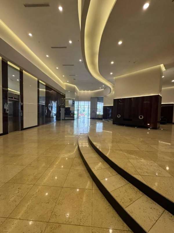 Spacious lobby with marble floors, modern lighting, and reception at PH Oasis on the Bay in Punta Pacifica