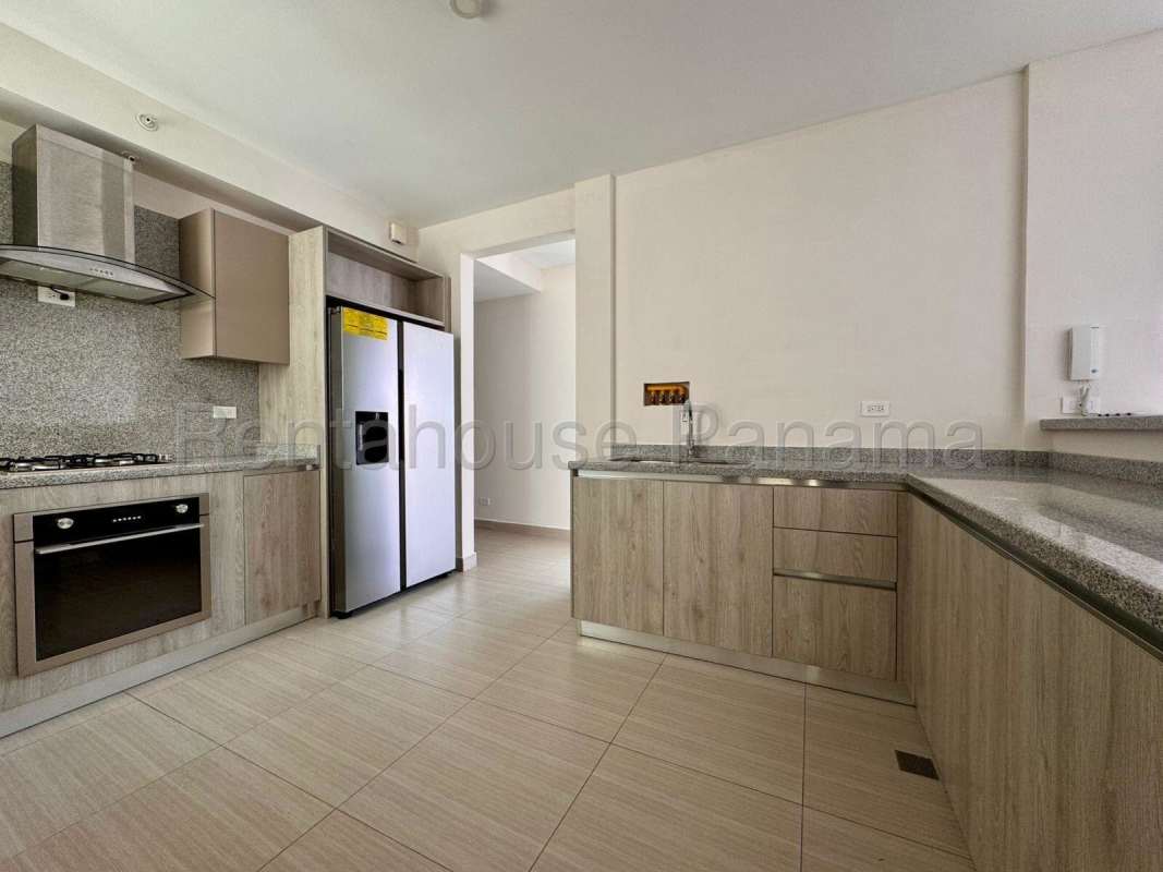 Contemporary kitchen with granite countertops and built-in appliances at PH Asia Costa del Este Panama
