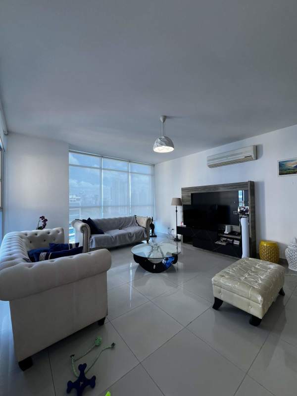 Custom walk-in closet with built-in wooden shelves and storage in apartment PH Astoria El Cangrejo