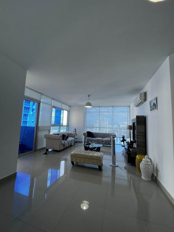 Living room with floor-to-ceiling windows overlooking Panama City skyline in PH Astoria