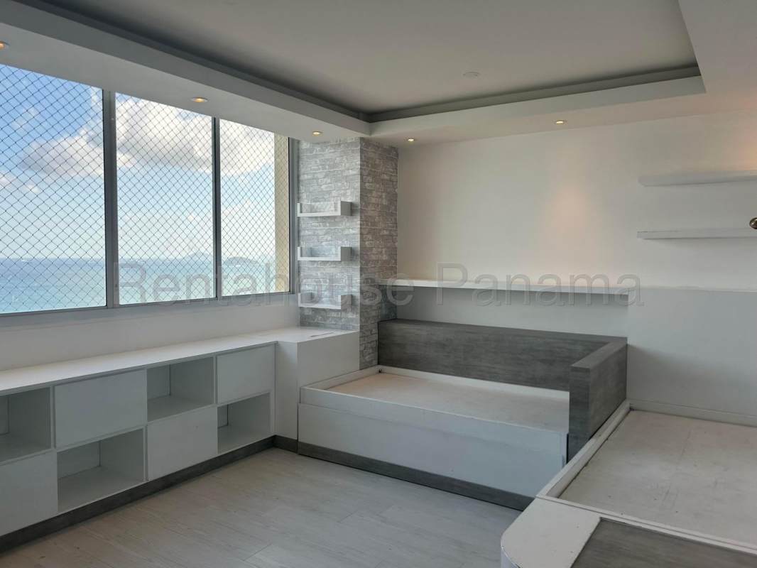 Spacious master bedroom with floor-to-ceiling windows, ocean views, marble floors PH Peninsula Punta Paitilla