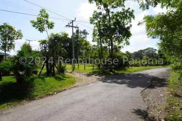 Paved road bordering open land parcel in La Chorrera western Panama