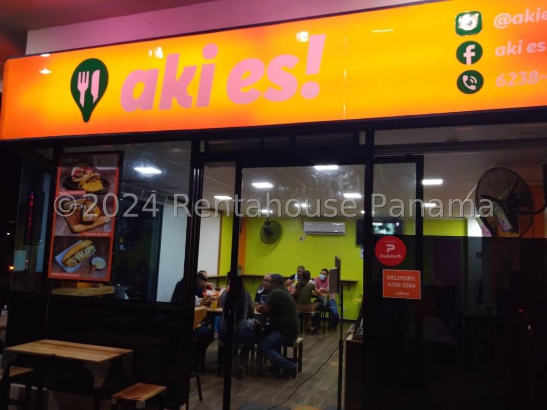 Spacious dining area with tables, chairs, counter and large store windows in restaurant AKI Plaza San Francisco Panama