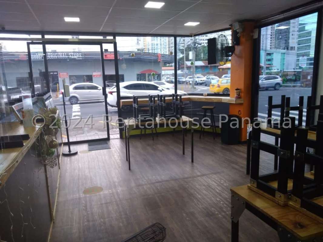 Industrial kitchen with stove, stainless steel countertops, triple sink in restaurant AKI Plaza Panama City