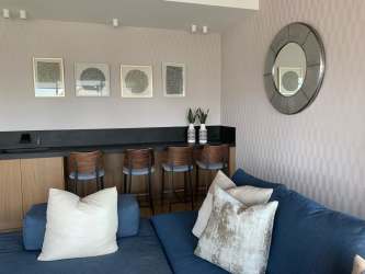 Dining space with glass table pendant lights marble wall Playa Escondida