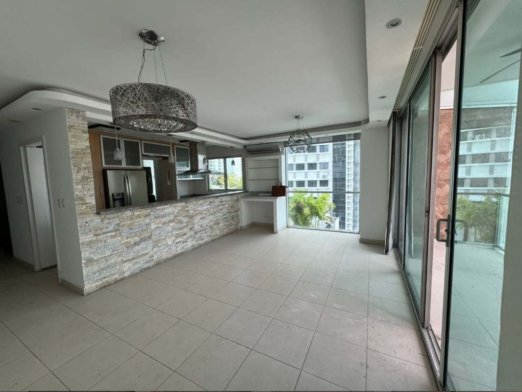 Living room with tile floors and access to balcony with city view in PH Tao San Francisco Panama