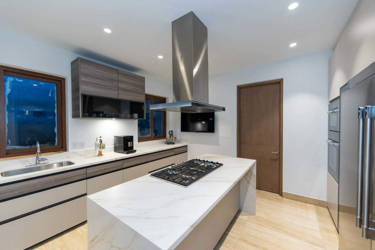 Modern minimalist kitchen large island stainless appliances marble countertop Santa Maria Panama