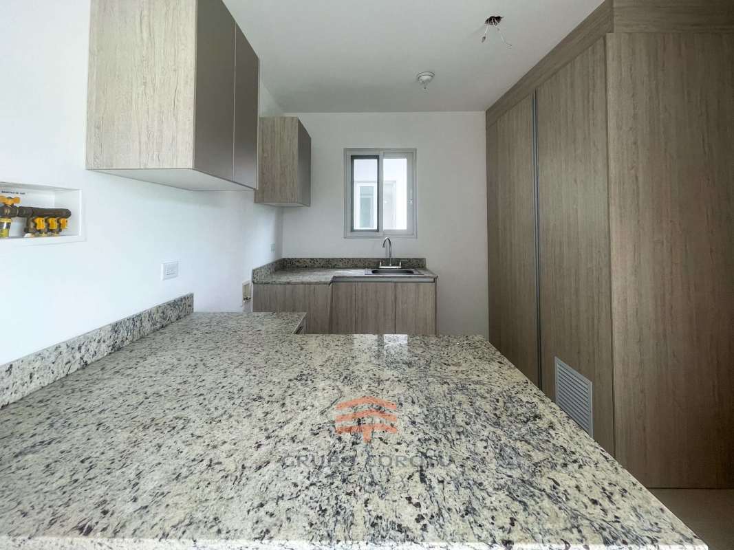 Bright open living and dining space with tile floors in Costa Sur new house