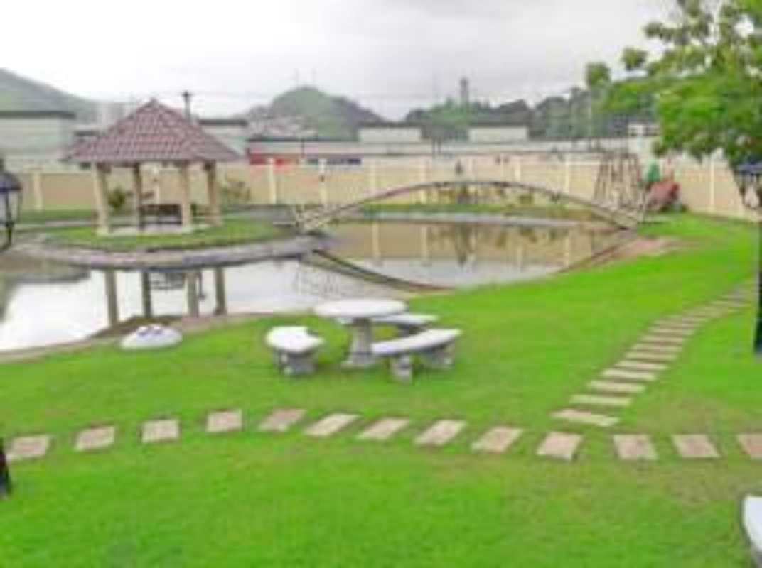 Resort-style swimming pool with waterfall and blue water slide in Condado del Rey complex Panama