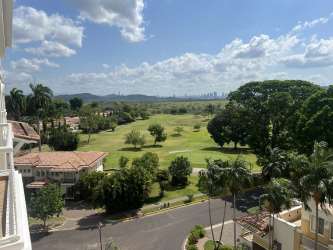 Panoramic golf course view with palm trees at Panama Pacifico Golf Residences