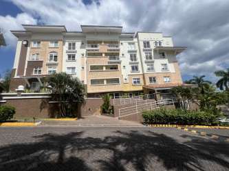 Modern multi-story residential building with balconies at Cocolí Golf Residences