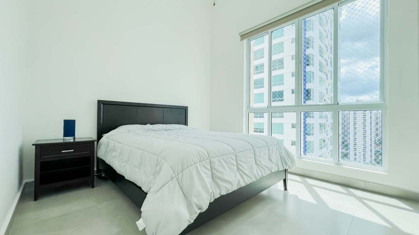 Master bedroom with city view, AC, built-in closet and minimal furnishings in PH Costa del Mar Panama
