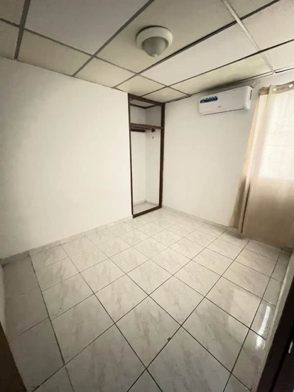 Bedroom with air conditioner and tiled floor in Don Bosco house Panama