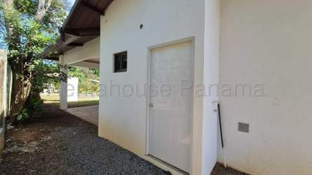 View of white minimalist house with glass door leading to garden at Villa Guadalupe David