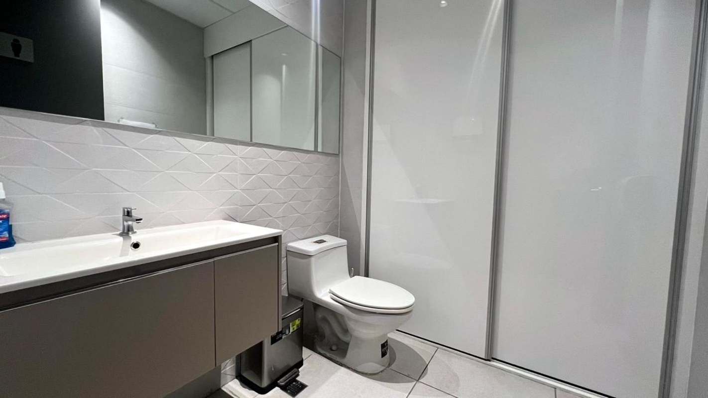 Small private office with built-in workstation, ergonomic chairs, glass divider in PH El Dorado Tower Panama