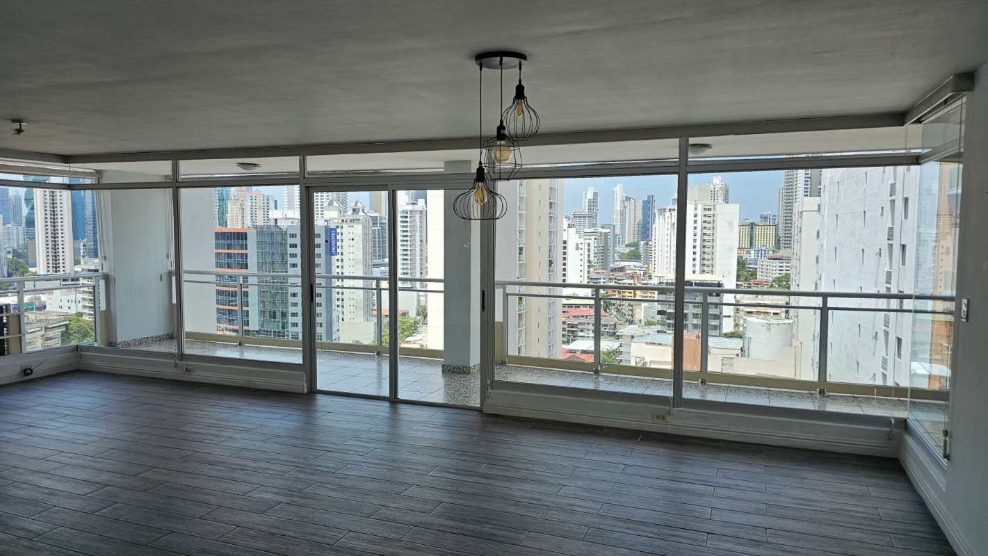 Bright spacious living room with panoramic views in PH El Carmen penthouse Panama City