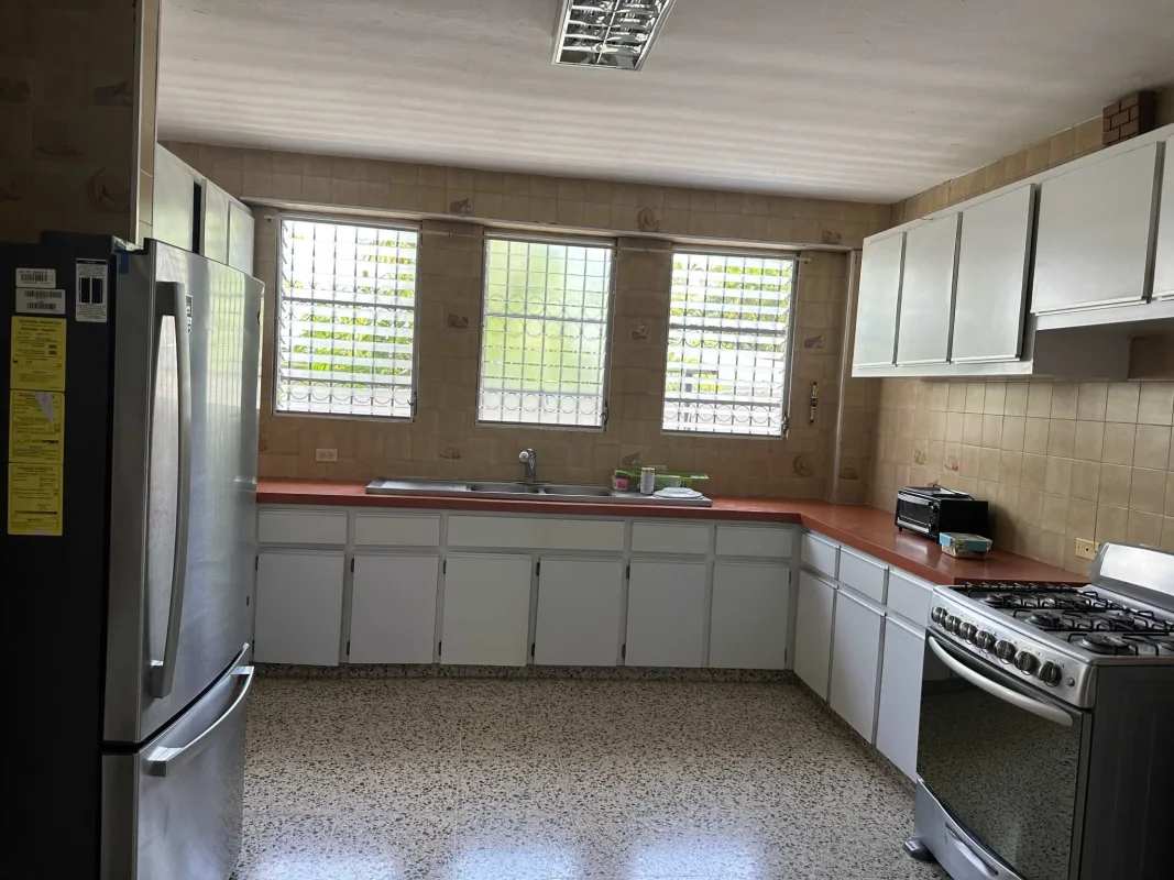 Spacious living room with large windows and terrazzo floor in Panama family house