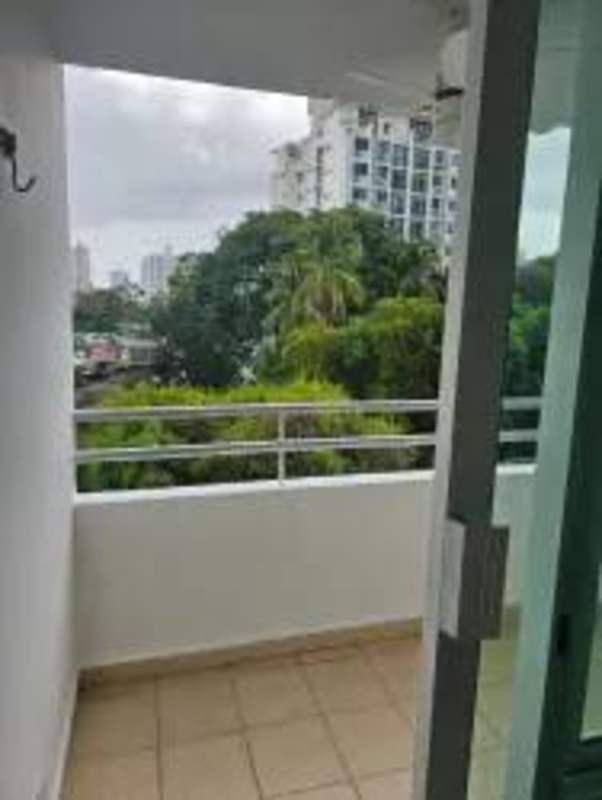 Balcony featuring metal railing overlooking urban landscape