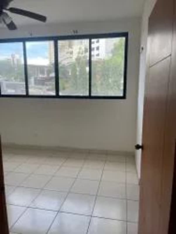 Empty bedroom with ceiling fan and large window in Carrasquilla