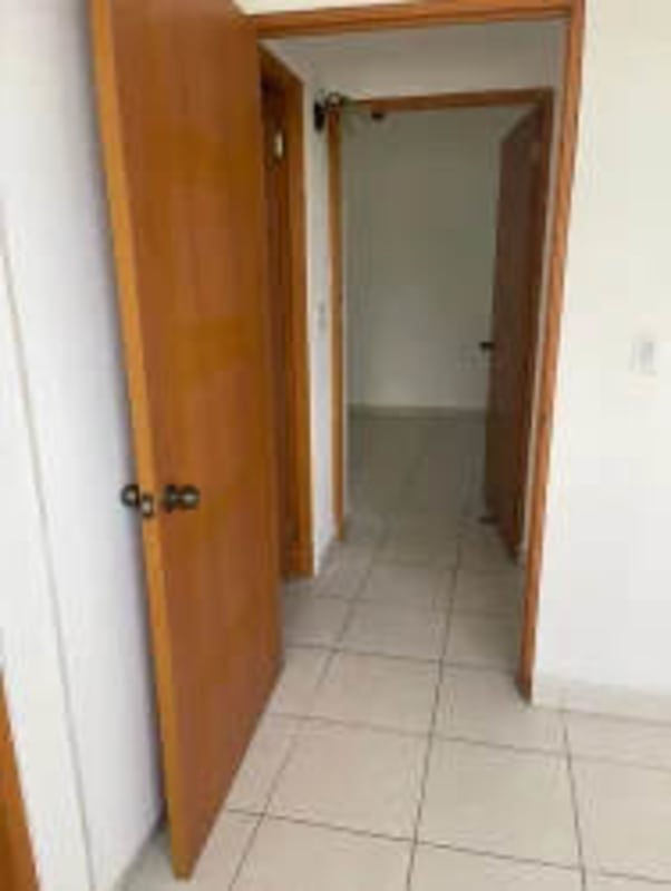 Unfurnished bedroom featuring built-in closet and large window