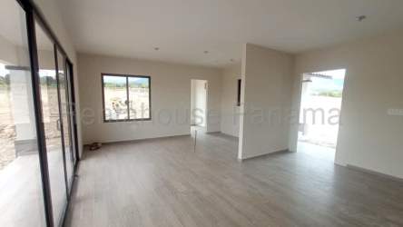 Living room with large windows overlooking mountain landscape in Panama property for sale